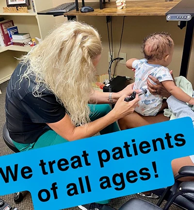 Chiropractor Kerrville TX Andrea Wilson Infant Adjustment Dr. Andrea Wilson uses a chiropractic tool to make a targeted adjustment in an infant's back